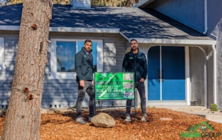 Residential Remodeling Contractors. Image of Green Group standing in front of a completed house.